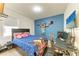 Comfortable bedroom with a gamer theme, desk, and blue accent wall at 16934 Oval Rum Dr, Wimauma, FL 33598