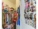 Organized walk-in closet with hanging clothes, shoe boxes, and accessories at 16934 Oval Rum Dr, Wimauma, FL 33598