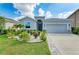 Charming single-story home boasts a meticulously landscaped front yard, enhancing its curb appeal at 16934 Oval Rum Dr, Wimauma, FL 33598
