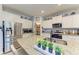 Modern kitchen with granite countertops, stainless steel appliances, and ample cabinet space at 16934 Oval Rum Dr, Wimauma, FL 33598