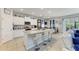 Bright kitchen featuring a granite island, stainless steel appliances, and bar stool seating at 16934 Oval Rum Dr, Wimauma, FL 33598