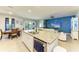 Open kitchen layout with a granite island, modern appliances, and seamless flow to the living area at 16934 Oval Rum Dr, Wimauma, FL 33598