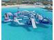 A captivating lagoon offers a range of inflatable structures and water activities for community residents at 16934 Oval Rum Dr, Wimauma, FL 33598