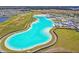 An expansive lagoon offers turquoise waters and recreational amenities within a Primary-planned community at 16934 Oval Rum Dr, Wimauma, FL 33598