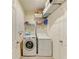 Well-organized laundry room with front load washer, dryer, shelving, and additional storage options at 16934 Oval Rum Dr, Wimauma, FL 33598