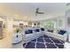 Open-concept living room with sectional sofa, kitchen, dining area, and recessed lighting at 16934 Oval Rum Dr, Wimauma, FL 33598