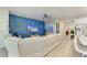 Bright, open living area with blue accent wall, modern furnishings, and tile flooring at 16934 Oval Rum Dr, Wimauma, FL 33598