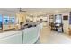 Open-concept living space with white kitchen, dining area, and large sectional sofa at 16934 Oval Rum Dr, Wimauma, FL 33598