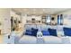 Open-concept living space with blue accents, sectional sofa, and modern kitchen at 16934 Oval Rum Dr, Wimauma, FL 33598