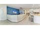 Bright, open living area with blue accent wall, modern furnishings and open kitchen at 16934 Oval Rum Dr, Wimauma, FL 33598