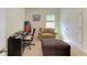 Home office space with a chair, ottoman and small table near a window at 16934 Oval Rum Dr, Wimauma, FL 33598