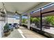 Enclosed patio with ceiling fan, comfortable seating, and an outdoor view, perfect for relaxation and entertaining at 16934 Oval Rum Dr, Wimauma, FL 33598