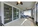 Enclosed patio with ceiling fans, comfortable seating, and access to backyard, perfect for relaxation at 16934 Oval Rum Dr, Wimauma, FL 33598