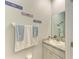 Stylish powder room with vanity, mirror, and decorative wall art at 16934 Oval Rum Dr, Wimauma, FL 33598