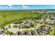 Stunning aerial view of a home nestled in a lush neighborhood with a pond and green space at 18734 Burndall Ct, Land O Lakes, FL 34638