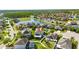 Picturesque aerial view of a home in a community featuring a pond, well-maintained lawns, and serene surroundings at 18734 Burndall Ct, Land O Lakes, FL 34638