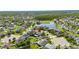 Overhead view of a charming home in a community with a pond, surrounded by lush greenery and manicured lawns at 18734 Burndall Ct, Land O Lakes, FL 34638