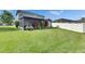 Expansive backyard featuring a well-maintained lawn, screened enclosure, privacy fence and landscaping at 18734 Burndall Ct, Land O Lakes, FL 34638
