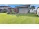 View of the large backyard showing the lawn, screened in enclosure, and privacy fence at 18734 Burndall Ct, Land O Lakes, FL 34638