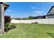 Spacious, fenced backyard featuring lush green grass and well-maintained landscaping at 18734 Burndall Ct, Land O Lakes, FL 34638