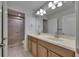 Bathroom with double sink vanity, large mirror, and shower at 18734 Burndall Ct, Land O Lakes, FL 34638