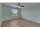 The bedroom has a light blue accent wall, wood-look floors, and a window with blinds at 18734 Burndall Ct, Land O Lakes, FL 34638