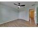 Light green bedroom with wood floors, ceiling fan, and window for natural light at 18734 Burndall Ct, Land O Lakes, FL 34638