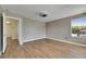 Bedroom with wood flooring, neutral wall colors, and a single window at 18734 Burndall Ct, Land O Lakes, FL 34638