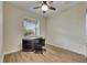 Cozy bedroom with hardwood floors, ceiling fan and a window providing natural light at 18734 Burndall Ct, Land O Lakes, FL 34638