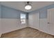 This bedroom features a neutral decor, wood-look flooring, and a window for natural light at 18734 Burndall Ct, Land O Lakes, FL 34638