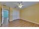 Bright bedroom featuring wood floors, double closet, and ceiling fan at 18734 Burndall Ct, Land O Lakes, FL 34638