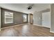 Bedroom with wood-look floors, neutral walls, and three windows at 18734 Burndall Ct, Land O Lakes, FL 34638