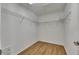 Walk-in closet with wood-look floors and wire shelving for storage solutions at 18734 Burndall Ct, Land O Lakes, FL 34638