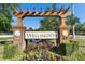 Attractive Wellington community sign under a pergola, set amidst lush landscaping at 18734 Burndall Ct, Land O Lakes, FL 34638