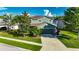 A beautiful two-story home features a well-manicured lawn and attractive landscaping for enhanced curb appeal at 18734 Burndall Ct, Land O Lakes, FL 34638