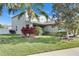 Well-manicured lawn and landscaping highlight this two-story home at 18734 Burndall Ct, Land O Lakes, FL 34638