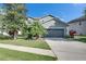 Charming two-story home with a well-maintained lawn, beautiful landscaping, and attached two car garage at 18734 Burndall Ct, Land O Lakes, FL 34638