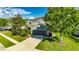 Attractive two-story home with well-manicured lawn, healthy mature trees, and a spacious driveway leading to a two-car garage at 18734 Burndall Ct, Land O Lakes, FL 34638