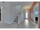 Spacious tiled foyer with staircase, neutral walls, and glass front door for natural light at 18734 Burndall Ct, Land O Lakes, FL 34638