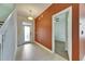 Open foyer with tile floor, staircase, accent wall, and views to a bedroom with ceiling fan at 18734 Burndall Ct, Land O Lakes, FL 34638