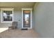 Charming front porch with tiled flooring, neutral paint, and chair for enjoying the outdoors at 18734 Burndall Ct, Land O Lakes, FL 34638
