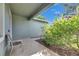 Inviting front porch area with a chair, tiled surface, and decorative bushes at 18734 Burndall Ct, Land O Lakes, FL 34638
