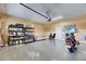 Organized garage with shelving, epoxy flooring, and a motorcycle at 18734 Burndall Ct, Land O Lakes, FL 34638