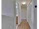 Hallway view featuring hardwood flooring and access to bathroom at 18734 Burndall Ct, Land O Lakes, FL 34638