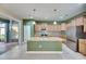 Gourmet kitchen features granite countertops, stainless steel appliances, and island with pendant lighting at 18734 Burndall Ct, Land O Lakes, FL 34638