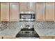 Close up of a modern kitchen featuring stainless steel appliances and granite countertops at 18734 Burndall Ct, Land O Lakes, FL 34638