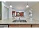 Kitchen island boasts granite counters and stainless sink with views to living and dining areas at 18734 Burndall Ct, Land O Lakes, FL 34638