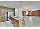 Spacious kitchen with granite island, stainless steel appliances, and an open view of the living room at 18734 Burndall Ct, Land O Lakes, FL 34638
