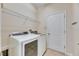 Laundry room with a washer, dryer, and shelving for storage at 18734 Burndall Ct, Land O Lakes, FL 34638