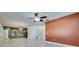 Bright and open living space with tile flooring, ceiling fan, and open kitchen at 18734 Burndall Ct, Land O Lakes, FL 34638